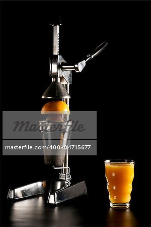 Classic metal juicer with gapefruit and juice