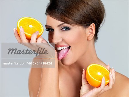 Portrait of beautiful woman, she holding fresh orange