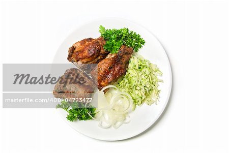 Grilled meat with sauce and vegetables isolated on white background