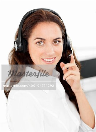 Positive woman with headset working in a call center against a white background