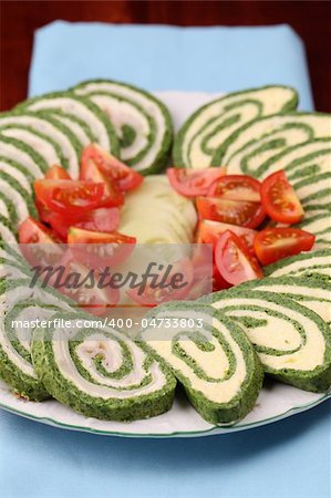 Two kinds of spinach rolls,  with eggs and cheese and with garlic cheese and ham. Shallow dof