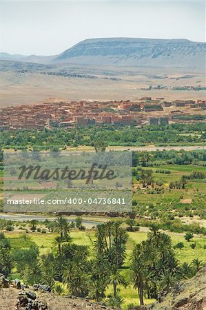 village and palm grove among Moroccan hills