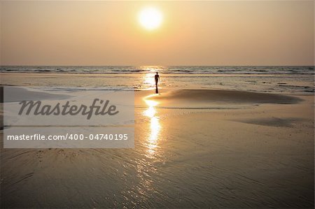 Glowing sunset on golden sands at varca beach Goa