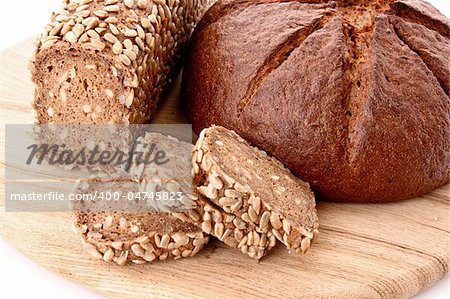 Bread on wooden plate isolated on white