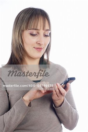 Young woman writing sms on mobile phone at isolated background