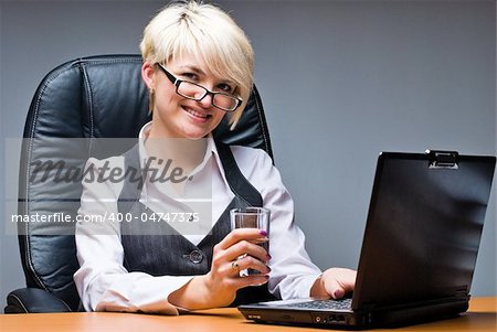 Business woman working on her laptop in office