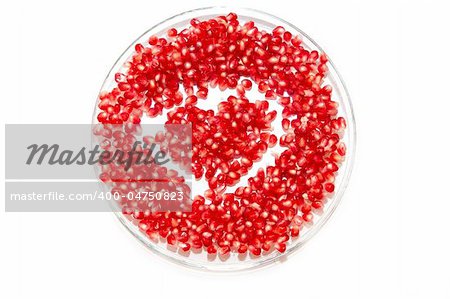 heart made by pomegranate seeds on the plate
