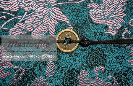 Traditional Chinese fabric sample with lucky coin