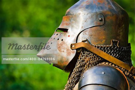 man in knight's helmet on a green background