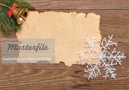 christmas decoration and old paper on brown wood texture