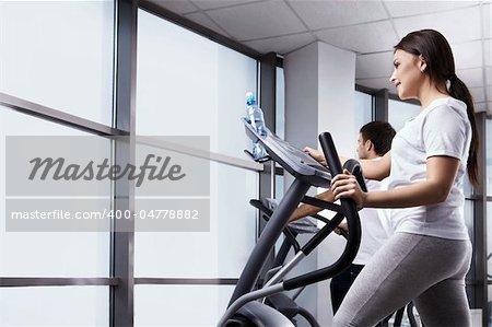 The nice girl is engaged in fitness club