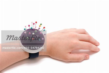 Purple pincushion bracelet with pins on the wrist,  isolated on white