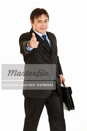 Elegant businessman with briefcase in hand pointing finger at you isolated on white