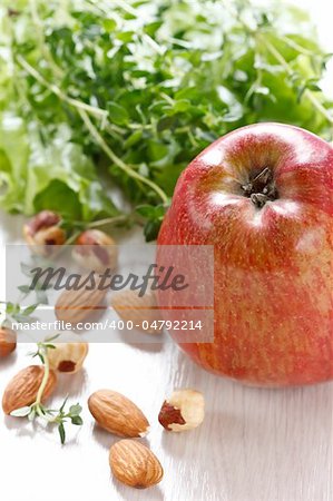 Healthy food concept. Apple, salad and nuts.