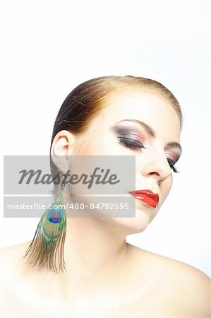 Young beauty female face with red shiny lips and black eye makeup. colse-up.