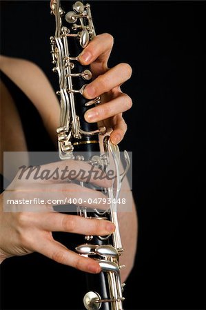 Women playing on clarinet. Hands closeup shot