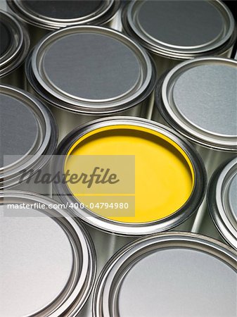 Paint cans full frame with a yellow can opened
