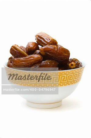dates in cup isolated on white