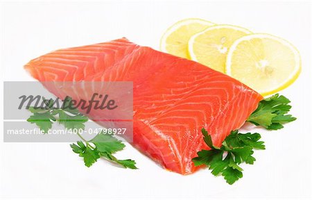 Salmon steak with lemon slices and parsley isolated on white background