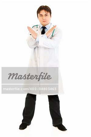 Serious medical doctor with crossed arms isolated on white. Forbidden gesture.