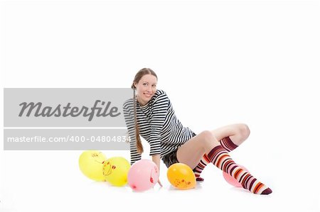 a pretty girl dressed in casual clothes playing with baloons