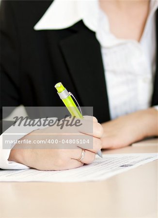hand of woman making notes in her notebook