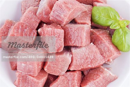 Bowl of diced beef over white background - close up