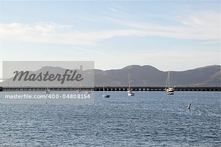 A seascape with boats and view on Golden Gate Bridge