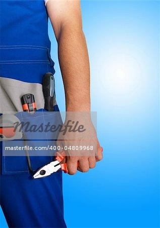 Closeup of repairman with pliers on blue background