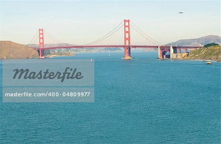 Airship or blimp cruising over San Francisco and the Golden Gate Bridge