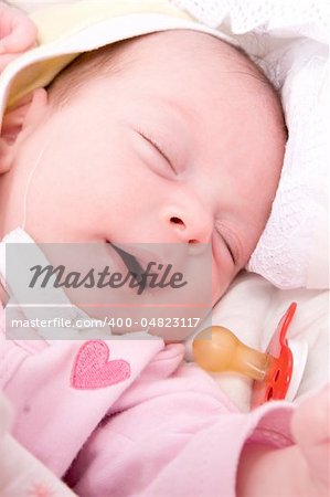 Sleeping baby girl in age of one month close up