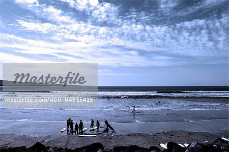 surfing school students being taught on the beach in lahinch county clare ireland on a beautiful day