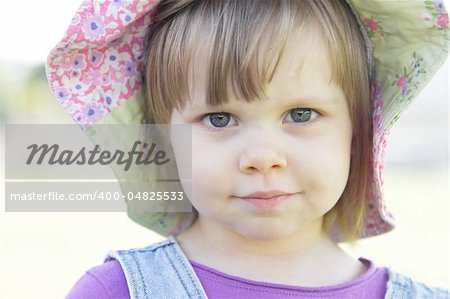 Cute little girl with a hat outdoors