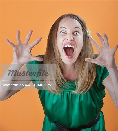 Scary attractive Caucasian woman on orange background