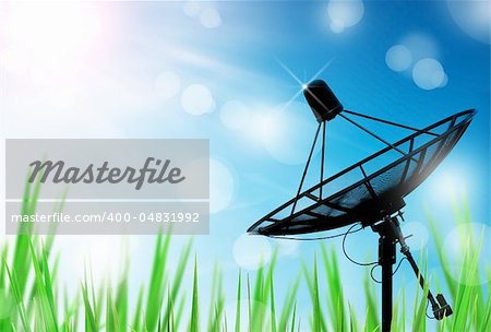 satellite dish antennas in field under sky and light reflect in morning