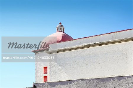 mexican white house with red dome above