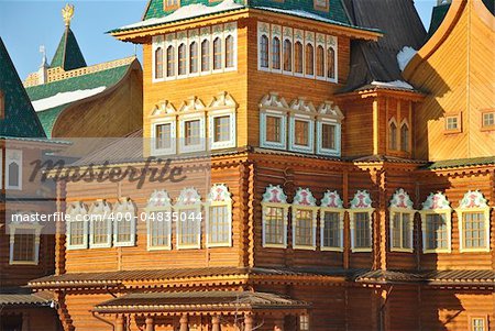 Wooden palace of Tsar Alexei Mikhailovich in Moscow in traditional Russian style at the background of a winter park.