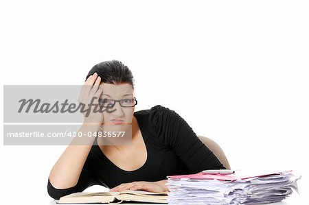 Bored young student woman at the desk , isolated on white background