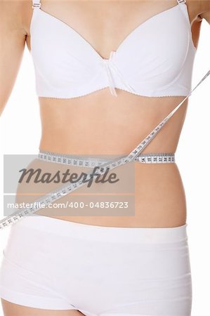 Beautiful woman measuring perfect shape of beautiful thigh waist. Healthy lifestyles concept . Isolated