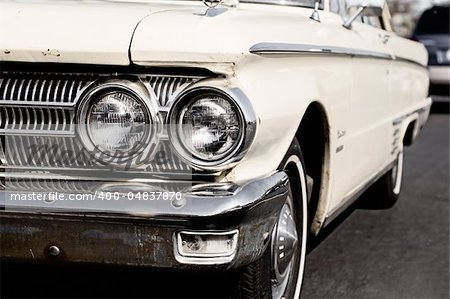 Antique american car on a parking lon on a bright sunny day