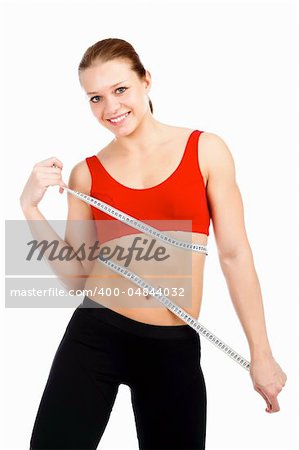 Sport woman with measuring tape posing against white background