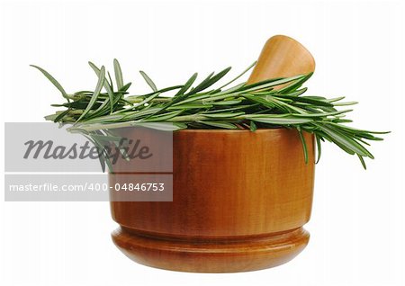 The kitchen herb rosemary with a wooden mortar isolated on white