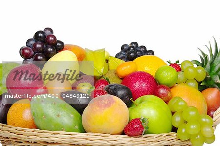 A big variety of exotic fruits in a basket from close