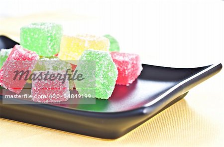 Marmalade candy on a dark plate.