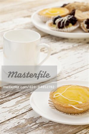 lemon mini tart and espresso coffee on a rustic wooden table