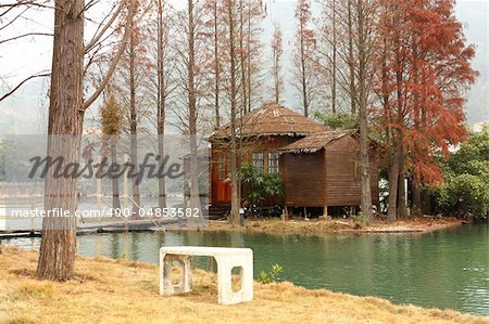 white chiar and house on water front property