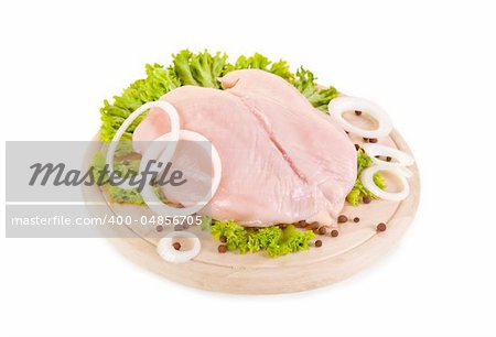 Fresh raw chicken breasts on chopping board, clipping path included