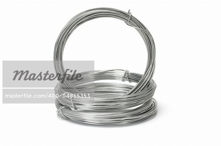 Coils of galvanized wires stacked on white background