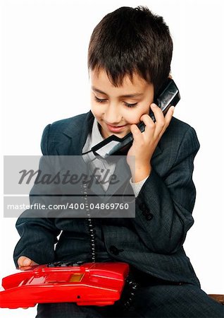 young boy talking on the phone isolated on white background