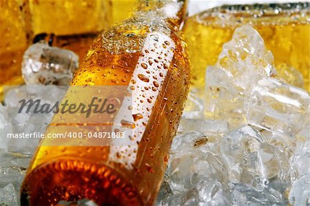 Bottles of cold beer lying in the ice. Close view.